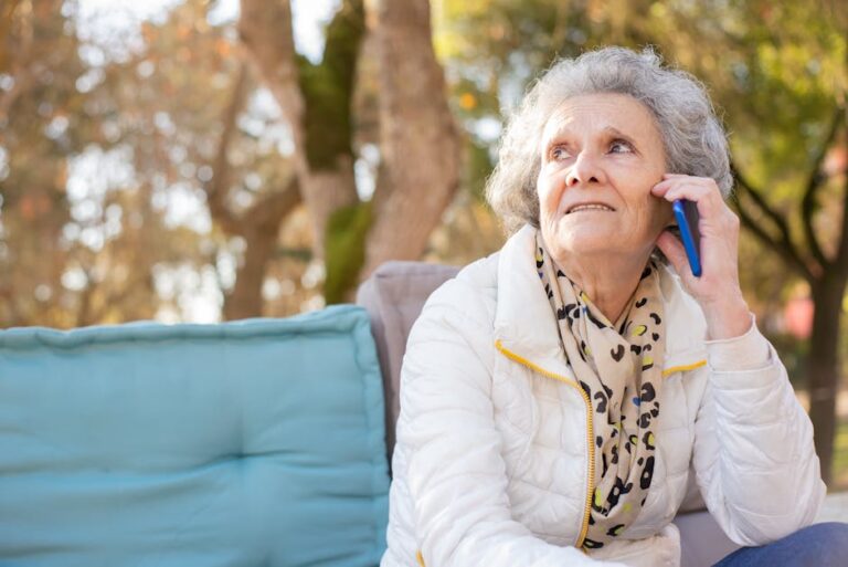 senior woman talking on mobile phone smiling - Photo by Kampus Production on Pexels