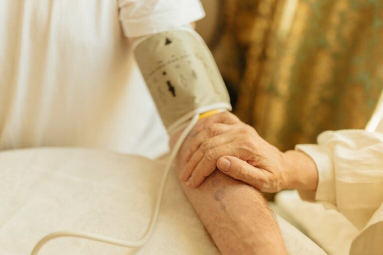 caregiver holding hands elderly person warm - Photo by Yaroslav Shuraev on Pexels