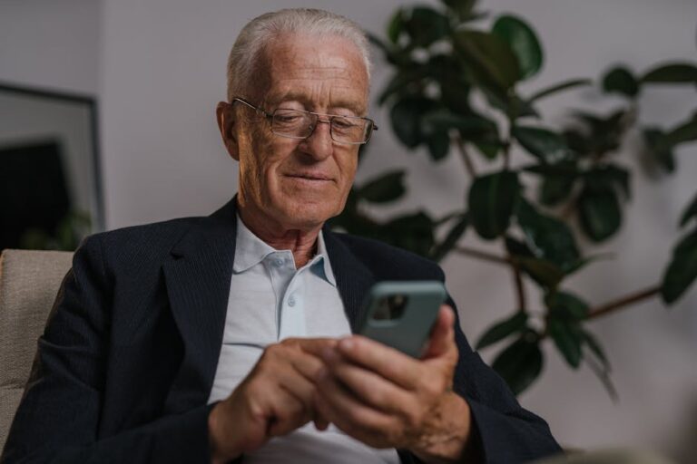 senior using technology home comfortable - Photo by SHVETS production on Pexels